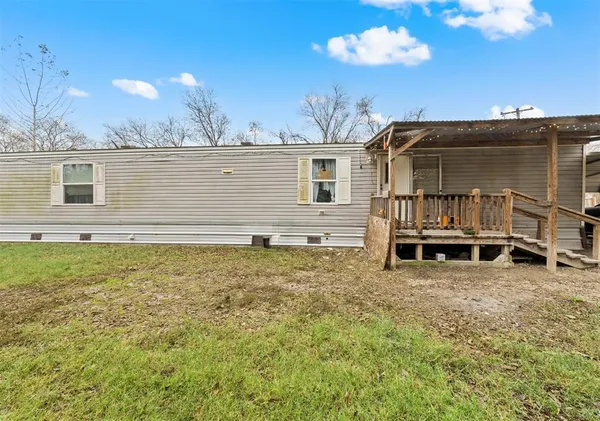 a view of a house with a wooden deck