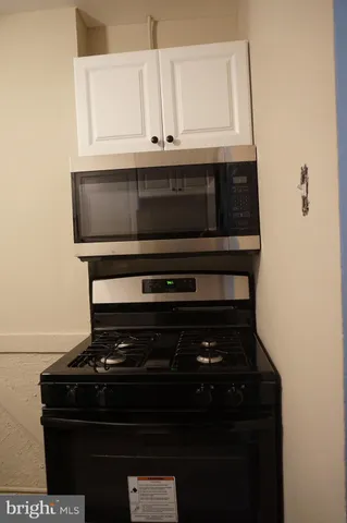a stove top oven sitting inside of a kitchen