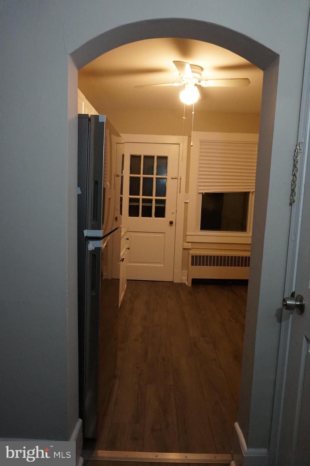 235 Cleveland Street Bristol, PA 19007 - Photo 9 of 18 a view of empty room with floor to ceiling window and ceiling fan