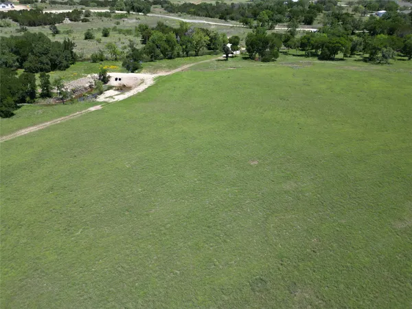 an aerial view of a golf course with a lake view