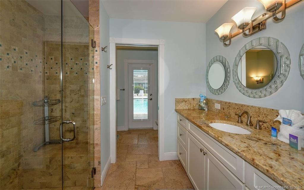 513 Gunwale Lane Longboat Key, FL 34228 - Photo 23 of 59 a bathroom with a granite countertop sink a mirror and a shower