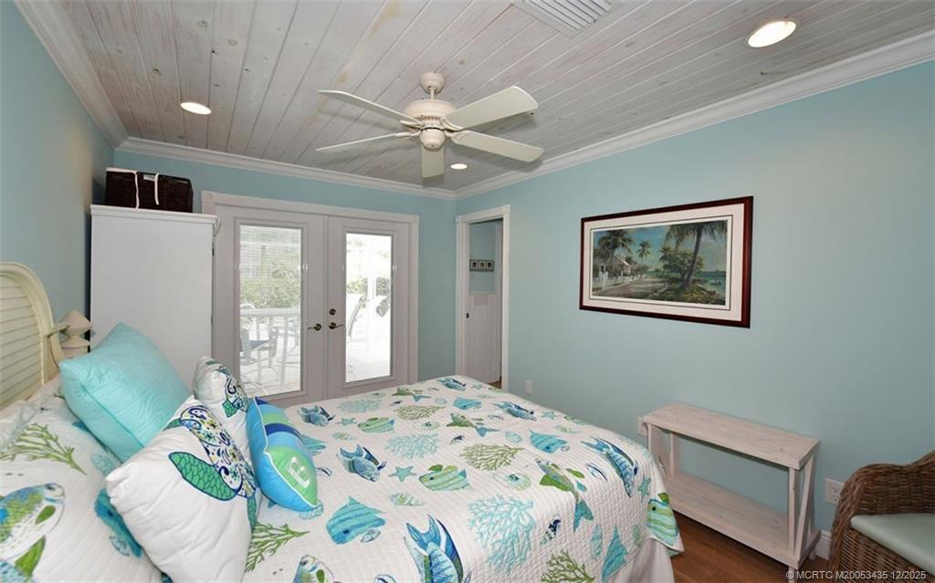 513 Gunwale Lane Longboat Key, FL 34228 - Photo 25 of 59 a bedroom with a bed and a chandelier
