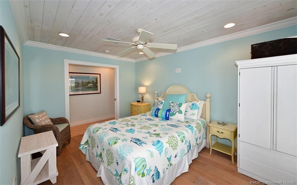 513 Gunwale Lane Longboat Key, FL 34228 - Photo 26 of 59 a bedroom with a bed and a chandelier