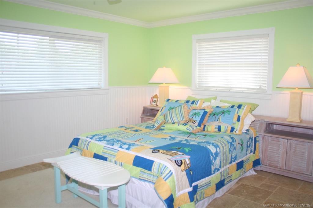 513 Gunwale Lane Longboat Key, FL 34228 - Photo 33 of 59 a bedroom with a bed and a table in it