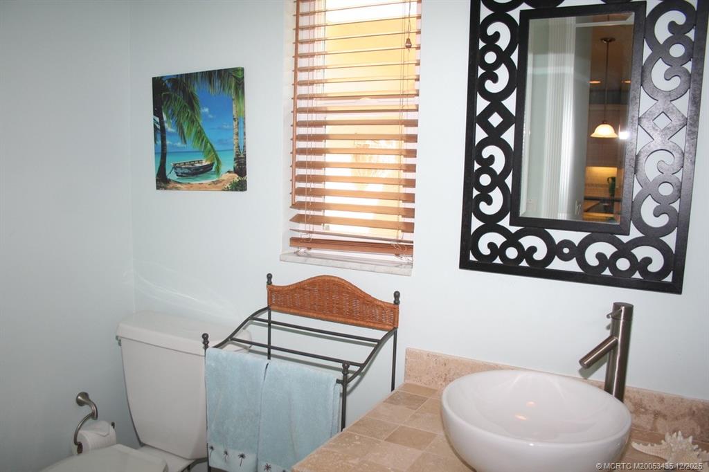513 Gunwale Lane Longboat Key, FL 34228 - Photo 34 of 59 a bathroom with a toilet a sink and a mirror