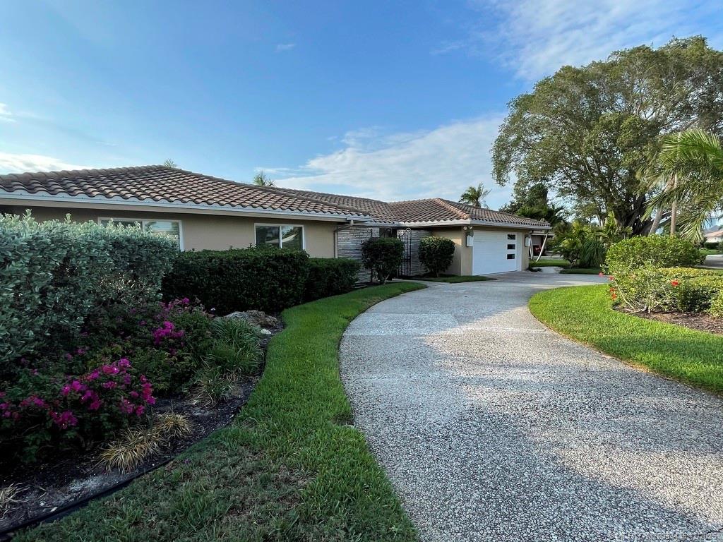 513 Gunwale Lane Longboat Key, FL 34228 - Photo 43 of 59 a front view of a house with garden