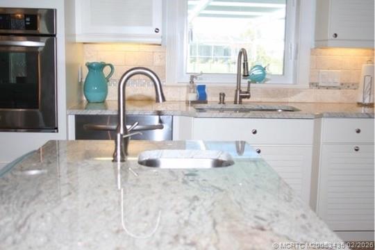 513 Gunwale Lane Longboat Key, FL 34228 - Photo 49 of 61 a kitchen with granite countertop a window and a sink