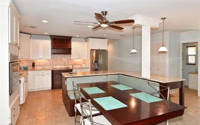 a large kitchen with kitchen island a island in the center