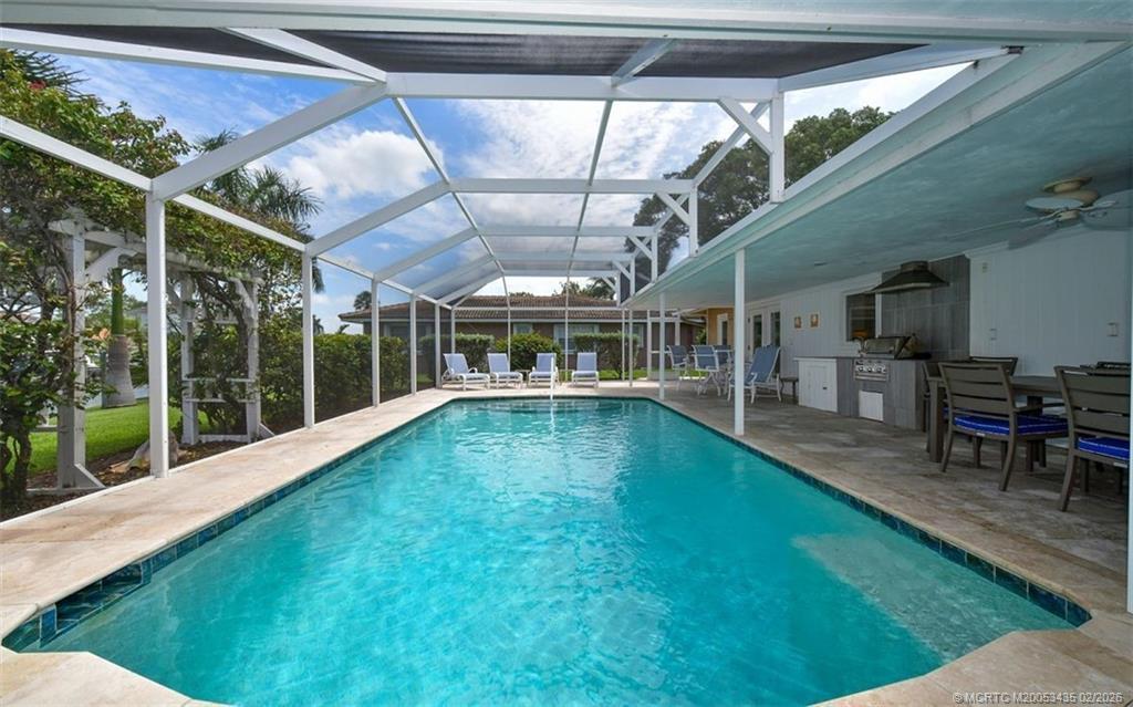 513 Gunwale Lane Longboat Key, FL 34228 - Photo 60 of 61 a view of a backyard with a table and chairs with wooden floor