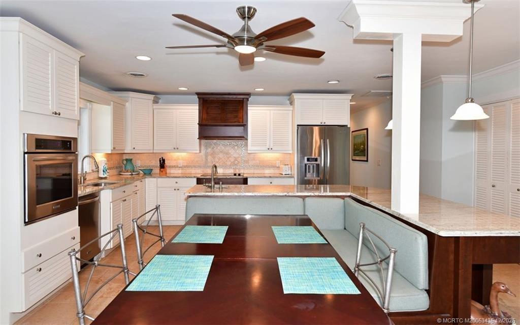 513 Gunwale Lane Longboat Key, FL 34228 - Photo 8 of 59 a large white kitchen with stainless steel appliances granite countertop a refrigerator and a stove top oven