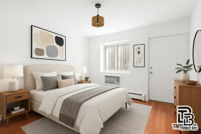 a bedroom with a bed and a painting on the wall