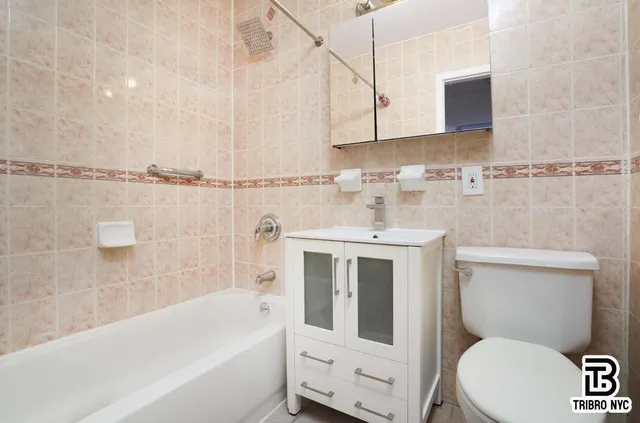 a bathroom with a sink a toilet and bathtub