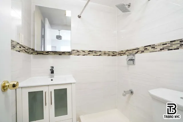 a bathroom with a sink a mirror and a shower