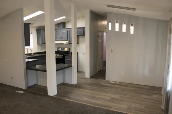 a kitchen with stainless steel appliances granite countertop wooden cabinets and a sink