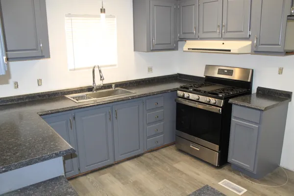 en empty room with wooden floor and mirror