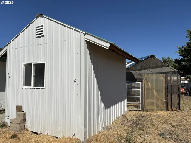a view of a house with wooden fence