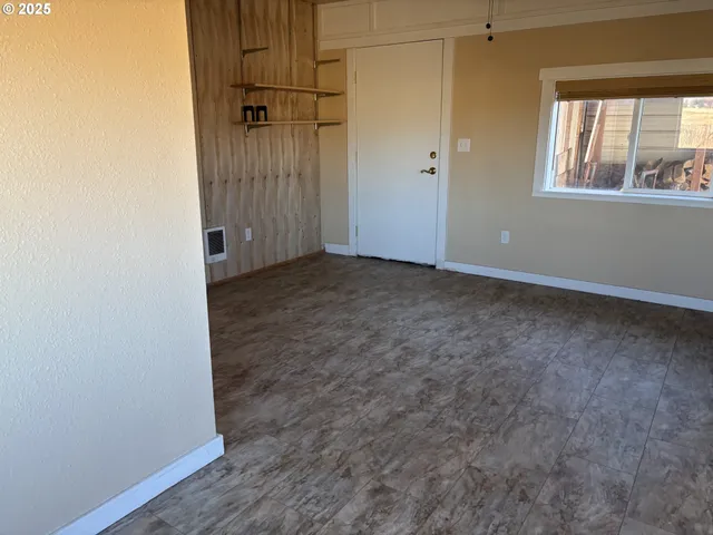 an empty room with windows and closet