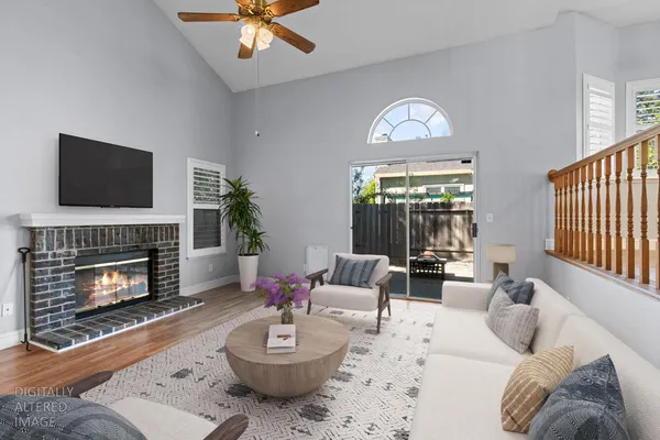 a living room with furniture a fireplace and a flat screen tv