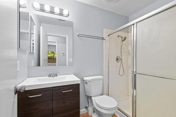 a bathroom with a sink vanity mirror and toilet