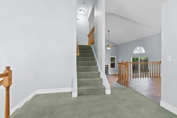 a view of entryway and hall with stairs