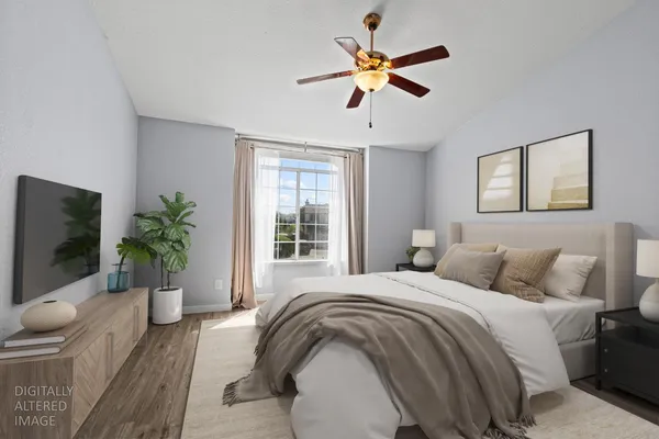 a bedroom with a balcony a bed and a chandelier