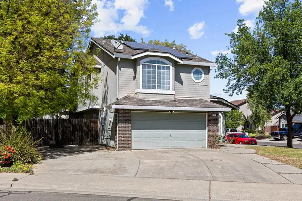 a view of a house with backyard and sitting area