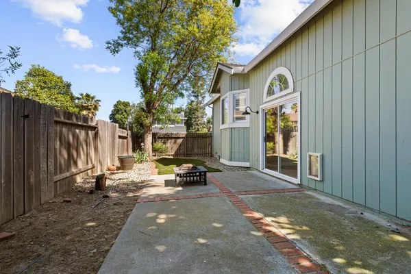 a backyard of a house with table and chairs