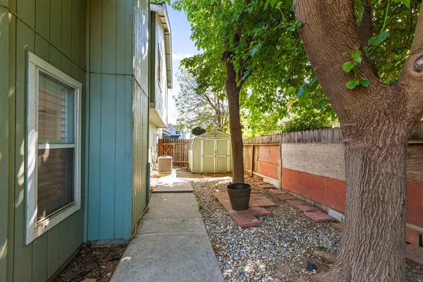 a backyard of a house with table and chairs