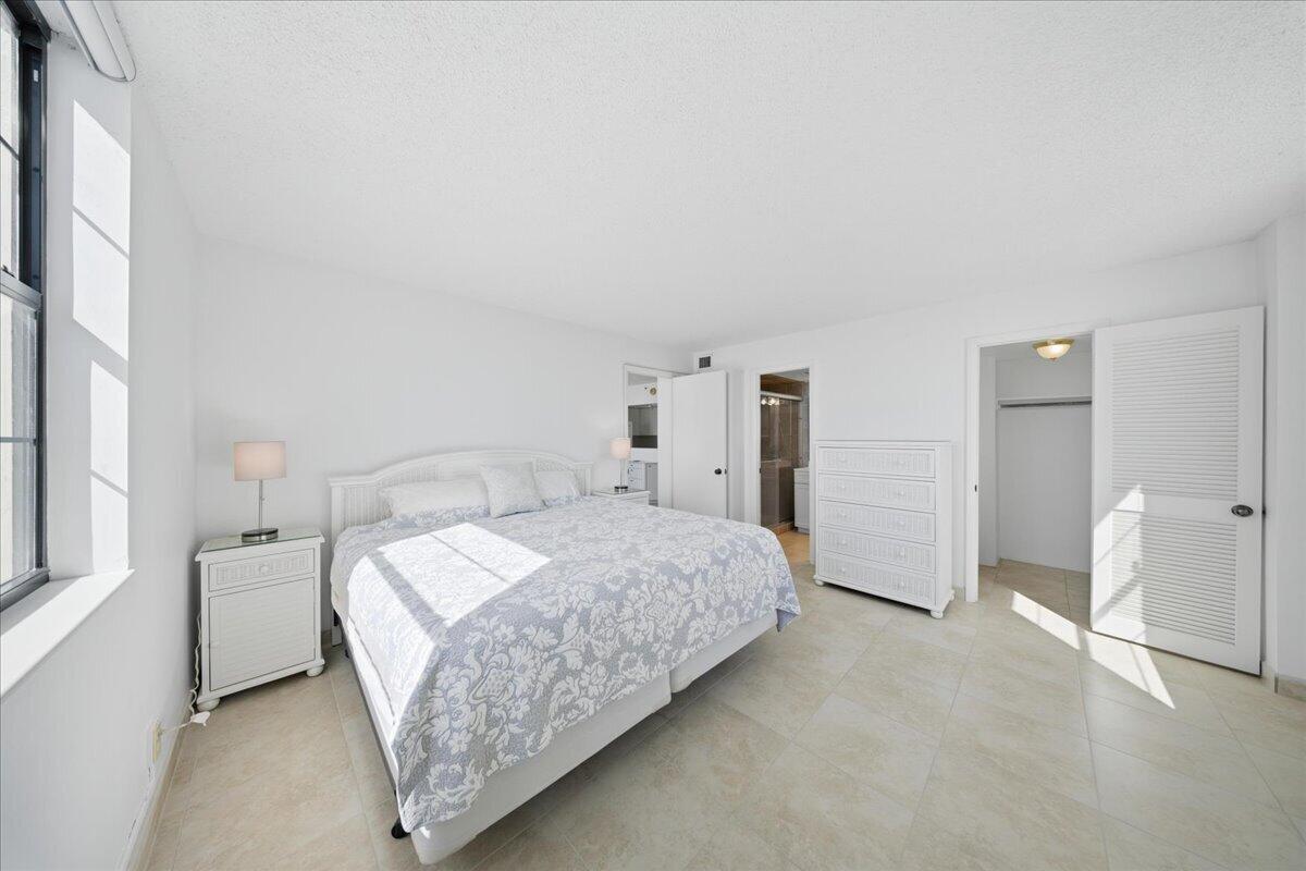 2000 Coco Plum Drive, Unit 601 Marathon, FL 33050 - Photo 16 of 45 a bedroom with a bed and a cabinets