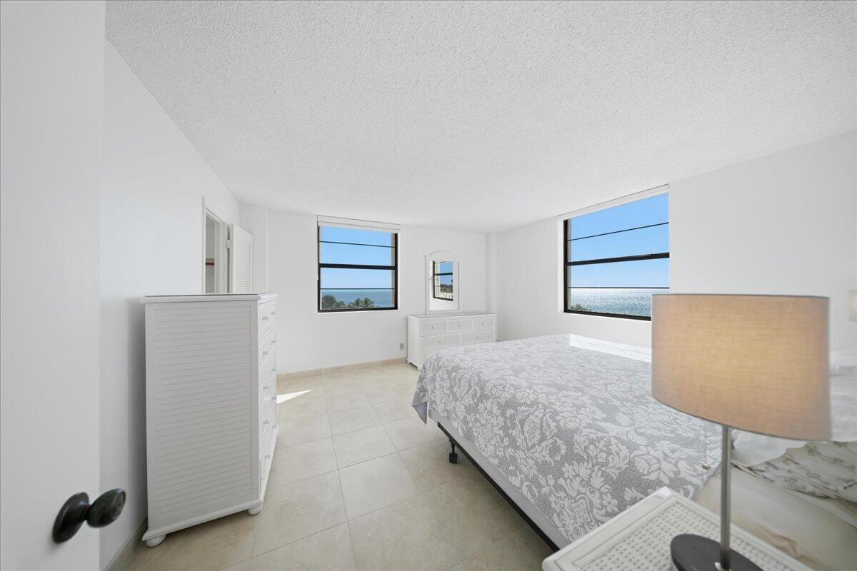 2000 Coco Plum Drive, Unit 601 Marathon, FL 33050 - Photo 17 of 45 a bedroom with a bed and a couch