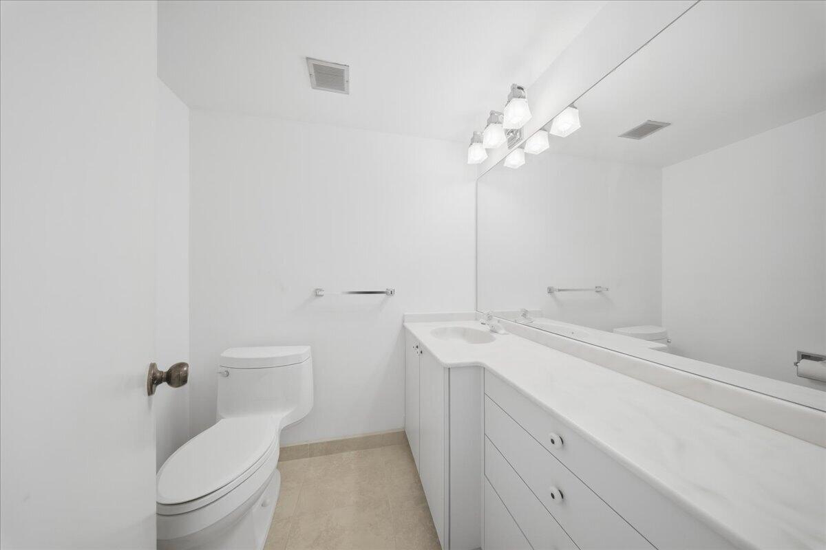 2000 Coco Plum Drive, Unit 601 Marathon, FL 33050 - Photo 26 of 45 a bathroom with a toilet sink and mirror