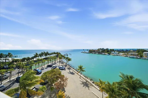 a living room with furniture a dining table and a chandelier