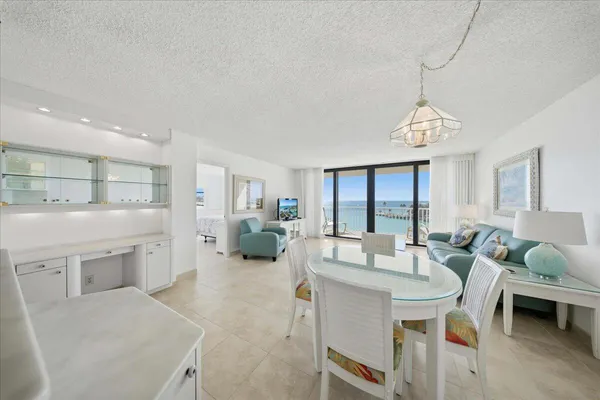 a large white kitchen with cabinets and a couch