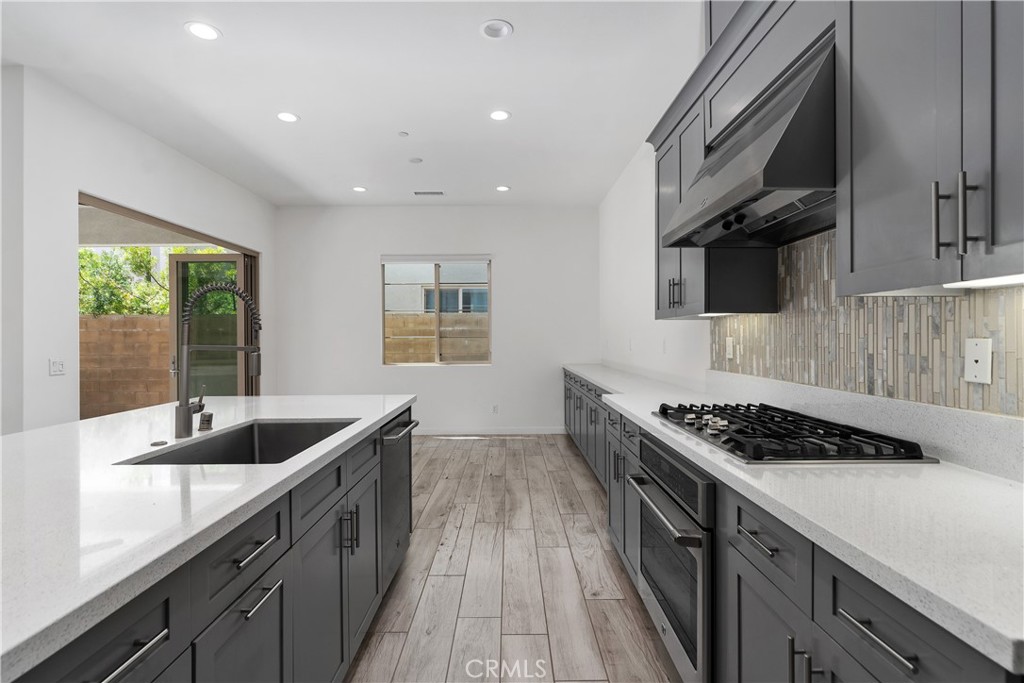 112 Menkar Irvine, CA 92618 - Photo 16 of 54 a kitchen with stainless steel appliances granite countertop a sink stove and cabinets
