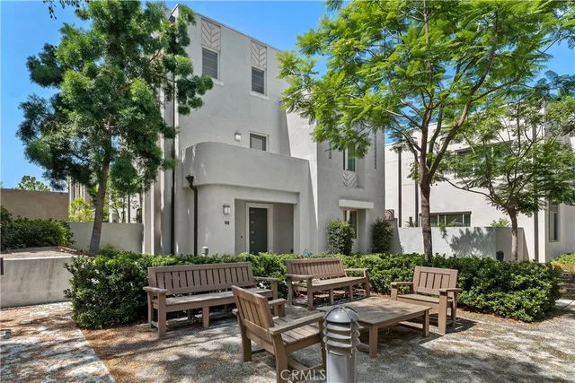 a view of a house with backyard sitting area and garden