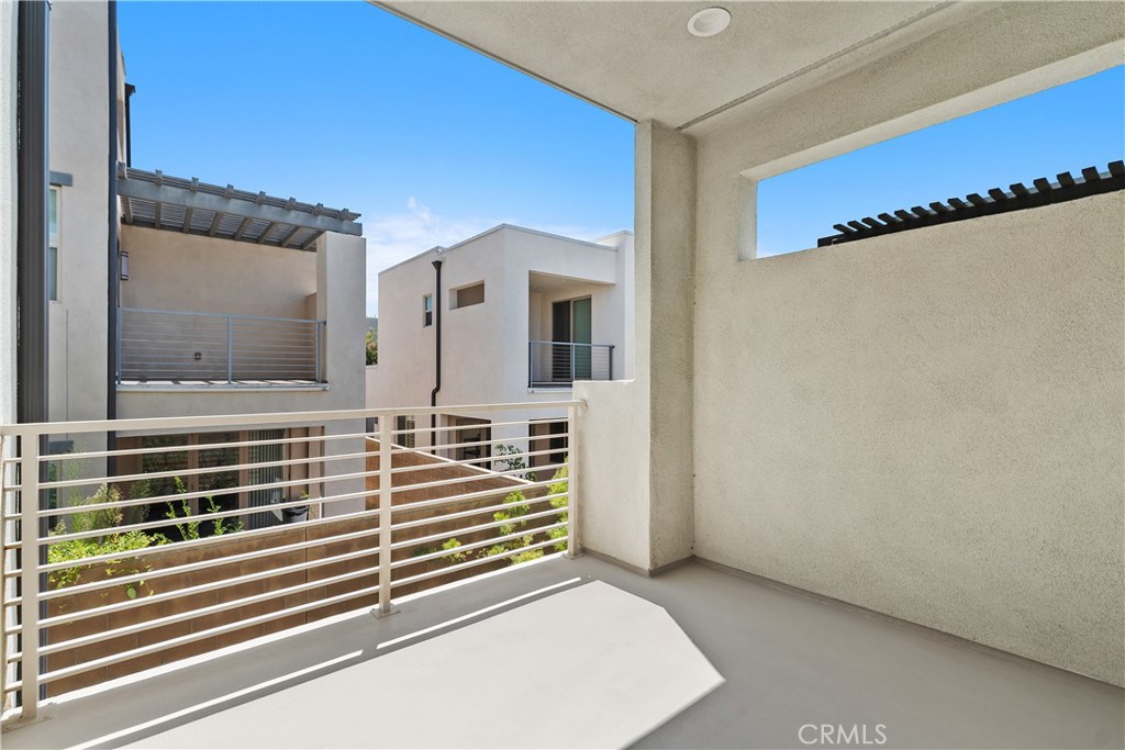 112 Menkar Irvine, CA 92618 - Photo 21 of 54 a view of a hallway with two couches and a kitchen view