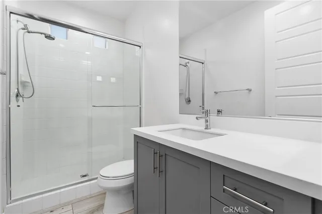 a bathroom with a sink toilet and shower