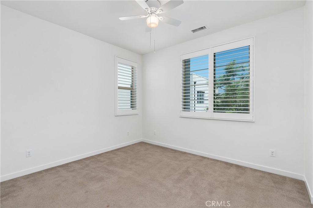 112 Menkar Irvine, CA 92618 - Photo 28 of 54 an empty room with a window and ceiling fan