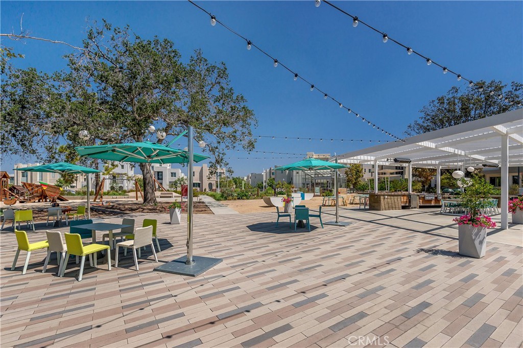 112 Menkar Irvine, CA 92618 - Photo 44 of 54 a view of a patio with table and chairs under an umbrella