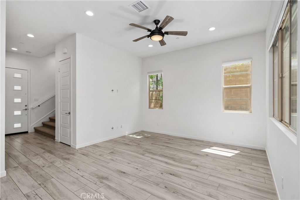112 Menkar Irvine, CA 92618 - Photo 5 of 54 an empty room with wooden floor and a ceiling fan