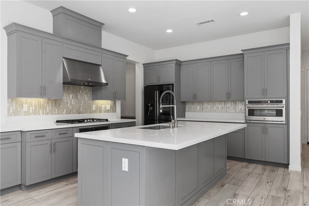 112 Menkar Irvine, CA 92618 - Photo 9 of 54 a kitchen with a sink a stove and refrigerator