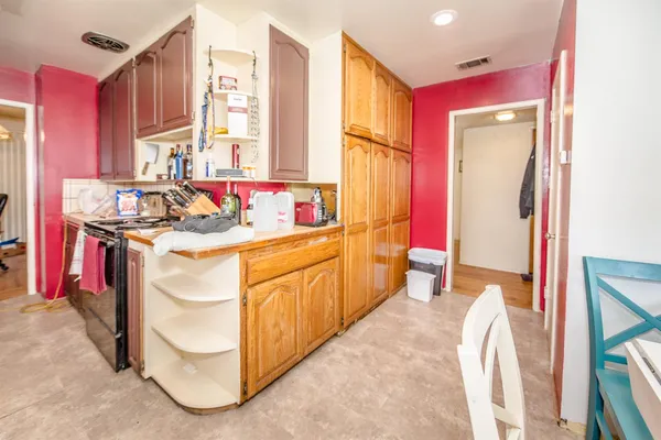 a kitchen with stainless steel appliances granite countertop a sink a stove cabinets and a window