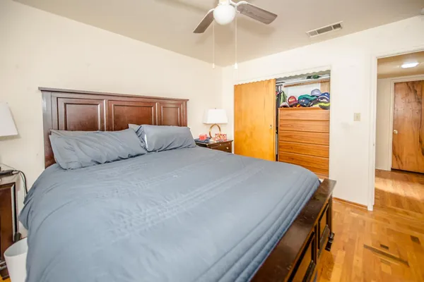 a bedroom with a bed and a chandelier