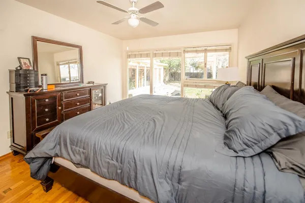 a spacious bedroom with a bed and a large window