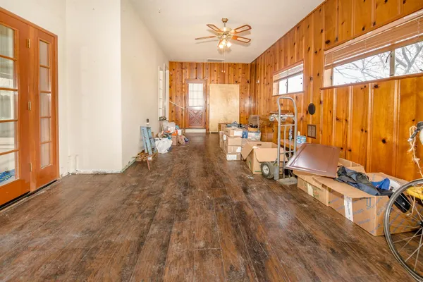a view of an empty room with furniture and a window