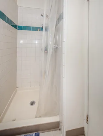 a bathroom with a sink a toilet and shower curtain