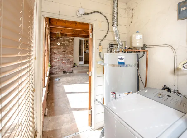 a view of a house with a small yard and flower plants