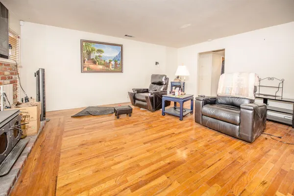 a bedroom with furniture and a flat screen tv