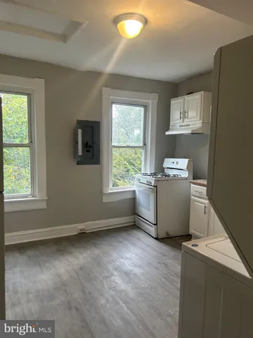 a view of kitchen with window and refrigerator