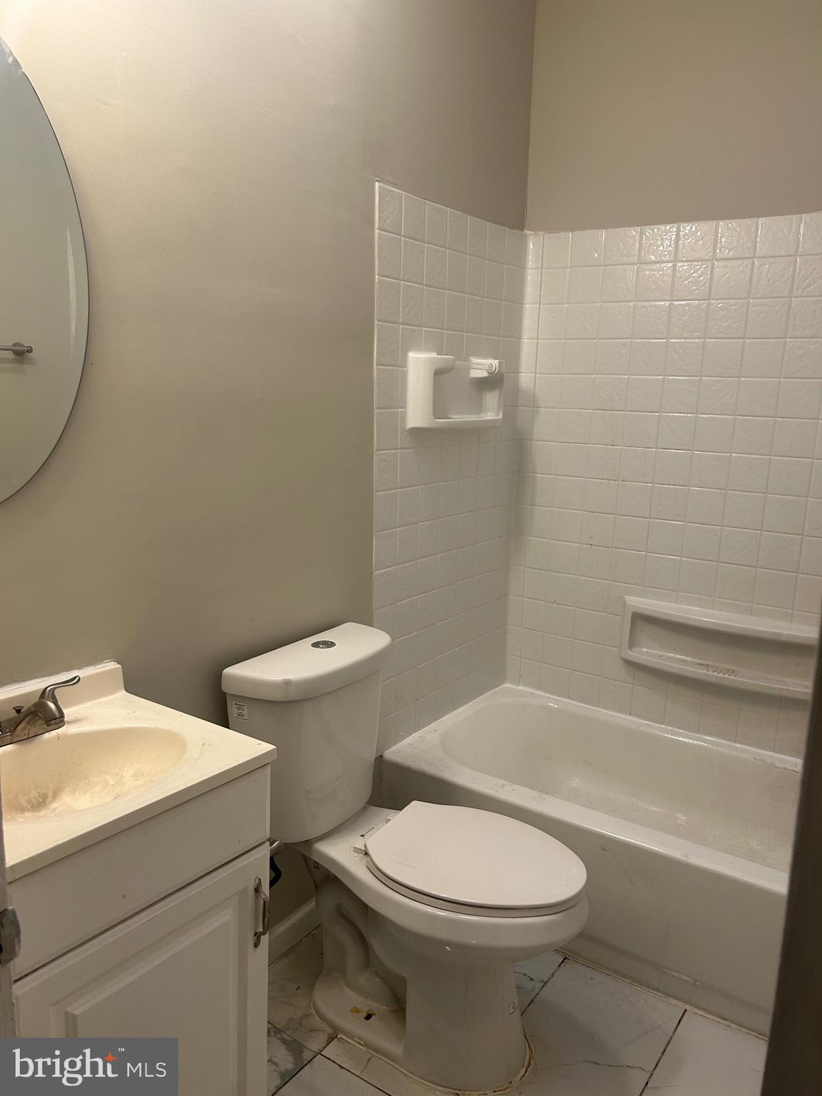 1503 East 28th Street, Unit 2 Baltimore, MD 21218 - Photo 9 of 9 a white toilet sitting next to a bath tub